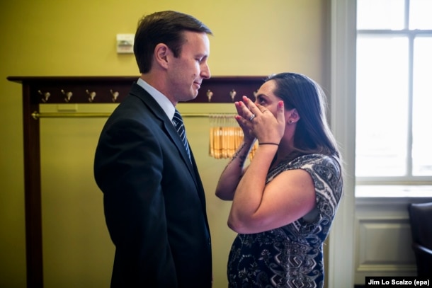 FILE - Democratic Sen. Chris Murphy of Connecticut breaks the news that the Senate failed to pass any of four procedural votes on new gun legislation to Erica Smegielski, daughter of slain Sandy Hook Elementary School Principal Dawn Hochsprung, at the Capitol in Washington, June 20, 2016.