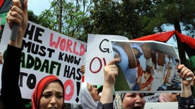 Libyan protesters shout slogans against Libyan leader Gadhafi in front of the Libyan embassy in Kuala Lumpur on February 23, 2011.