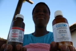 Nosele displays the medicines given to her by the health point nurse (D. Taylor/VOA)
