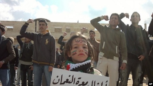 Demonstrators protest against Syria's President Bashar Al-Assad in Marat al-Numan near the northern province of Idlib. The bannr reads, "The children Marar Al-Numan, sacrifice our lives for you Bab Amro", March 2, 2012. 