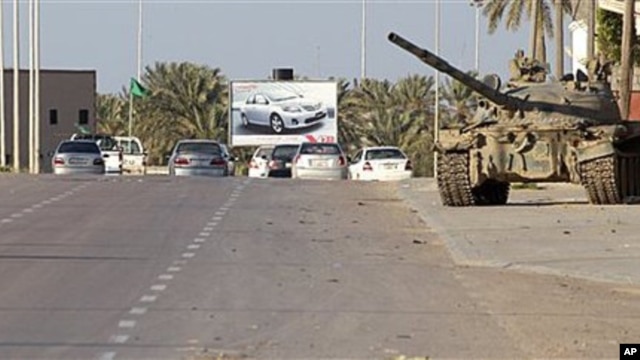 In this photo taken during a trip organized by Libyan authorities, a Libyan tank stands at in the outskirts of the coastal city of Misrata, 125 miles (200 kilometers) southeast of Tripoli, April 8, 2011