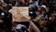 A student holds a placard during their protest against university tuition hikes outside the  ruling party African National Congress (ANC) headquarters in Johannesburg, South Africa, Thursday, Oct. 22, 2015. 