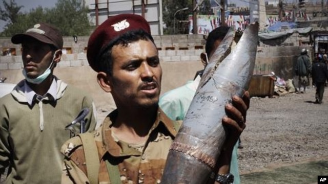 A defected army soldier shows an artillery shell allegedly fired by troops loyal to President Ali Abdullah Saleh in Sanaa, Yemen, October 27, 2011.