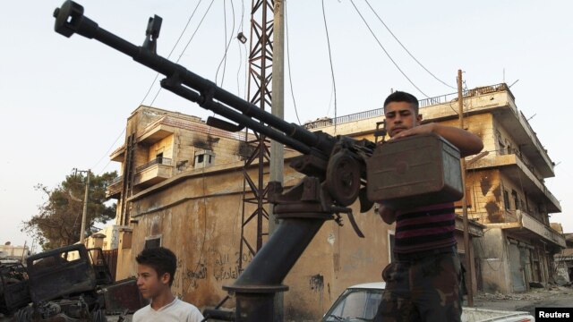 Binh sĩ thuộc Lực lượng Giải phóng Syria tuần tra tại Attarib, vùng ngoại ô thành phố Aleppo, ngày 30/7/2012