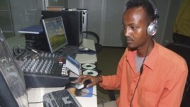 Hassan Yusuf monitors a computer in the control room during a live broadcast of the Somali government run radio.  Al-Shabab controls most of southern Somalia uses the Internet and radio stations to get its message out, FILE March 1, 2010.