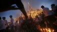 Mourners burn incense and offer prayers at the Royal Palace displaying a portrait of their former King Norodom Sihanouk in Phnom Penh, Cambodia, Wednesday Oct. 17, 2012. The body of Sihanouk returned to his homeland on a plane from China on Wednesday.