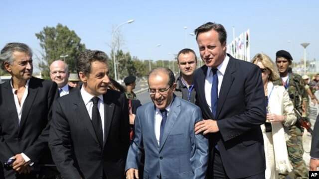 From left: French philosopher Bernard-Henri-Levy, France's President Nicolas Sarkozy, NTC PM Mahmoud Jibril, and Britain's PM David Cameron arrive at the Tripoli Medical Center, Sep 15, 2011.