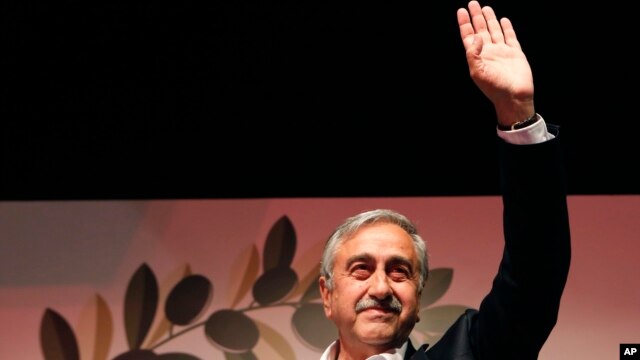 Newly-elected Turkish Cypriot leader Mustafa Akinci waves to supporters in Nicosia April 26, 2015.