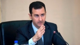 Syria's President Bashar al-Assad heads a Cabinet meeting in Damascus, in this handout photograph distributed by Syria's national news agency SANA on Feb. 12, 2013. 