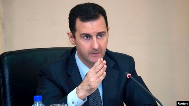 Syria's President Bashar al-Assad heads a Cabinet meeting in Damascus, in this handout photograph distributed by Syria's national news agency SANA on Feb. 12, 2013. 