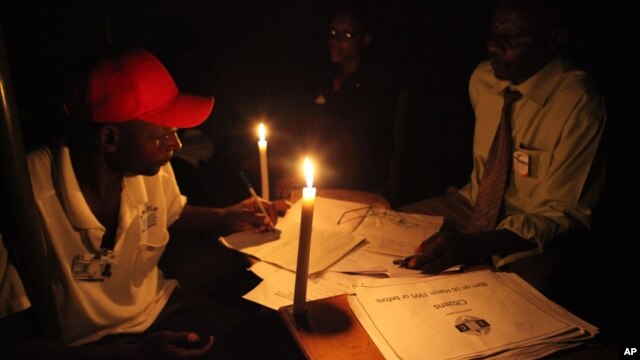 Polling officials are seen at a polling station  during the  country's referendum in the capital Harare, Mar. 16, 2013.
