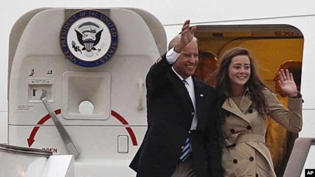 U.S. Vice President Joseph Biden and his daughter Ashley Biden wave after arriving at the Capital International Airport in Beijing, China, Wednesday, Aug. 17, 2011