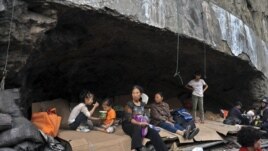 Residents rest in a stone cave, which becomes a temporary shelters after two earthquakes hit Yiliang, Yunnan province, China, September 8, 2012.  