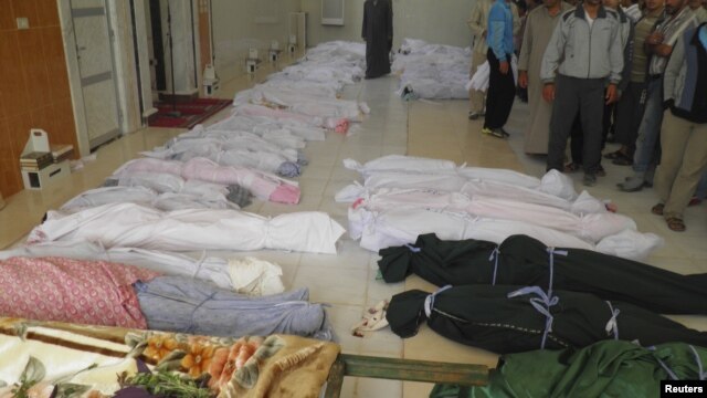 The bodies of people purportedly killed by Syrian government security forces are laid out in Houla near Homs, May 26, 2012.