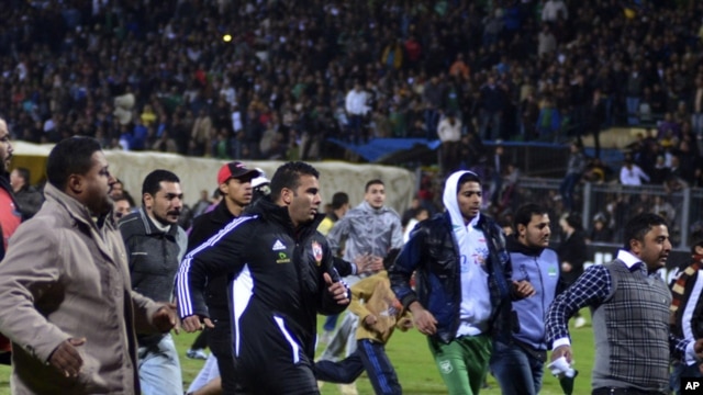 Football fans try to leave the stadium as chaos erupts at a soccer stadium in Port Said city, Egypt, February, 1, 2012. Seventy-three people were killed and at least 1,000 injured on Wednesday after a soccer pitch invasion in the Egyptian city of Port Sai
