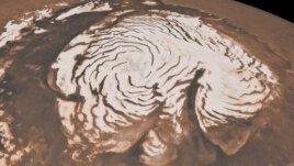 This image from two instruments aboard NASA’s Mars Global Surveyor, depicts an orbital view of the north polar region of Mars. New findings from the Mars Reconnaissance Orbiter have revealed subsurface geology in this region.