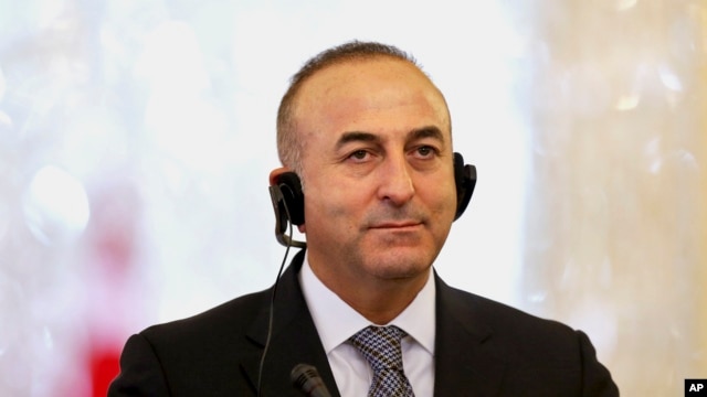 Turkish Foreign Minister Mevlut Cavusoglu listens to translation of a question in a joint press conference with his Iranian counterpart Mohammad Javad Zarif in Tehran, Iran, Dec. 17, 2014.
