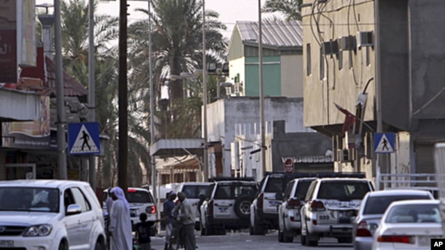 Riot police vehicles move through the streets of the western Shiite Muslim village of Malkiya, Bahrain, June 1, 2011
