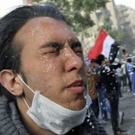 An injured protester receives treatment during clashes with riot police along a road leading to the Interior Ministry, near Tahrir Square in Cairo, November 23, 2011
