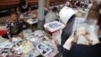 Vendors sell pictures of the royal family, as the country prepares for the funeral of Cambodia