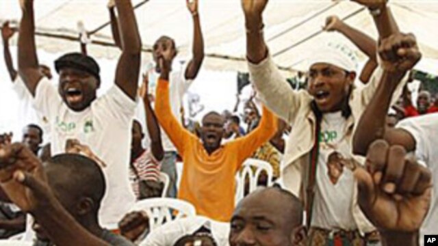 Supporters of opposition leader Alassane Ouattara, make their feelings known, as they sing at an event at a hotel in Abidjan, Ivory Coast, 30 Dec 2010