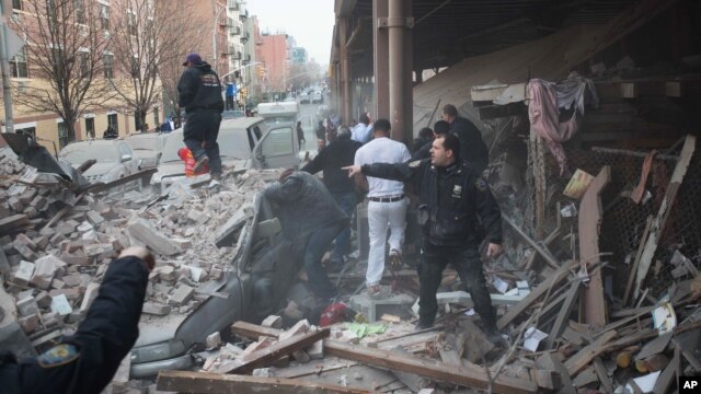 Police respond to the scene of an explosion and building collapse in the East Harlem neighborhood of New York, March 12, 2014. 