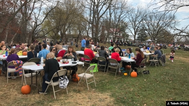 Visitors enjoy a vegan pot-luck picnic with the free-roaming turkeys at Poplar Spring Animal Sanctuary in Poolesville, Maryland.