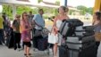 FILE - British tourists queue with their luggage to leave by charter flight from the international airport in Mombasa, Kenya.