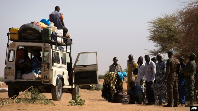 Malian people are controlled by Malian soldiers at a check point on February 23, 2013 in the center of northern Mali's largest city of Gao. 