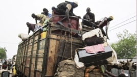 People load on onto a truck carrying residents fleeing south from an Islamic insurgency in northern Mali at the trading town of Mopti, June 19, 2012.
