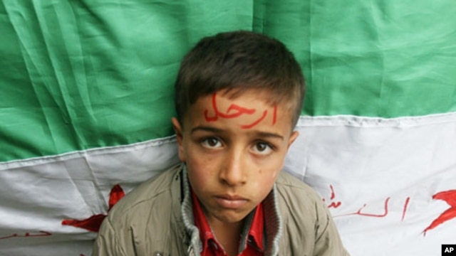 Syrian refugee with word 'Go' on his forehead, in reference to President Bashar al-Assad, northern Lebanon, Nov 12, 2011.
