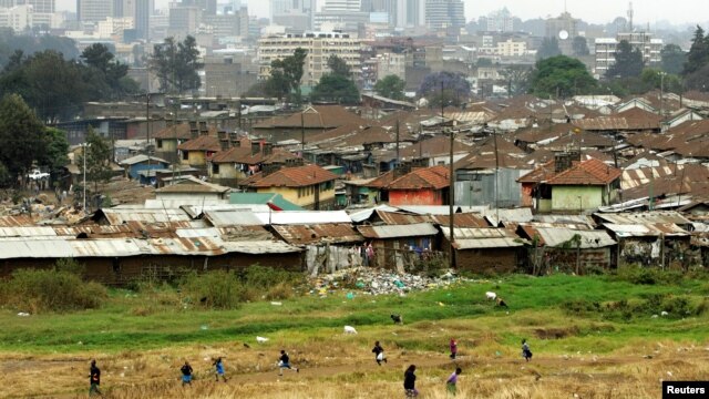 Children play on the way home after school in Pumwani slums near Kenya's capital Nairobi, seen in the background, September 14, 2006.
