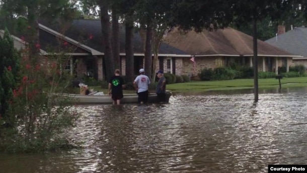 Three men prepare to kayak down their street to help out those in need, as well as find food and other supplies. (Photo courtesy of Abby TerHaar)