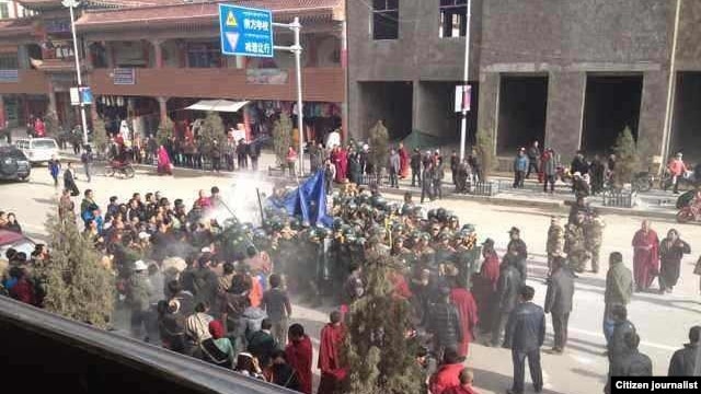 Citizen journalist image shows crowds surrounding Dorjee Rinchen, a Tibetan man who self-immolated in Labrang, China, October 23, 2012.