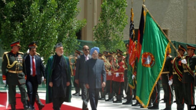 Indian Prime Minister. Manmohan Singh with the President of Afghanistan,  Hamid Karzai inspecting the Guard of Honor, at a ceremonial reception, on his arrival at Kabul airport in Afghanistan on May 12, 2011.