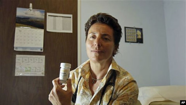 Dr. Lisa Sterman holds a bottle of Truvada pills that she prescribes for about a dozen patients at high risk for developing AIDS, at her office in San Francisco, May 20, 2012.