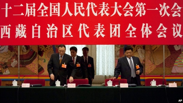 Champa Phuntsok, chairman of the Tibetan Autonomous Region’s people’s congress standing committee, left, and Tibet's governor Padma Choling, right, at a National People's Congress Tibetan delegate group's discussion session in Beijing.