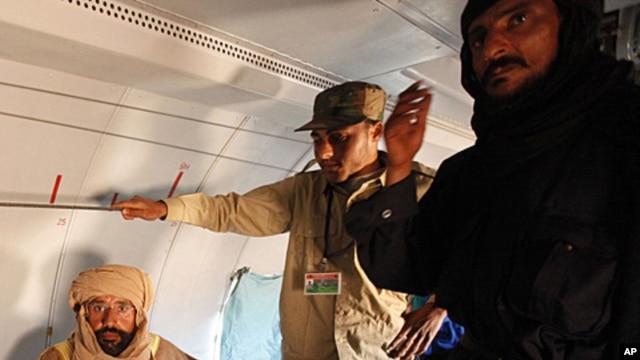 Saif al-Islam Gadhafi is pictured sitting in a plane in Zintan, Libya, November 19, 2011.
