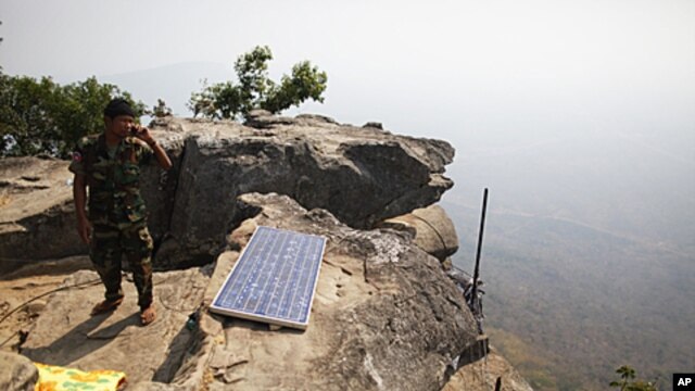 A Cambodian soldier talks on a phone from his position at the Preah Vihear temple on the border between Thailand and Cambodia, February 9, 2011. The UN's highest court has ordered both Cambodia and Thailand to immediately withdraw all troops from a newly 
