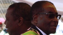 Zimbabwean President Robert Mugabe (R) and Prime Minister Morgan Tsvangirai arrive at a rally marking Zimbabwe's 31st independence anniversary celebrations in Harare, Zimbabwe, April 18, 2011. 