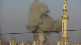 Smoke rises after a Syrian Air Force fighter jet loyal to Syria's President Bashar al-Assad fired missiles at Deraa November 4, 2012.