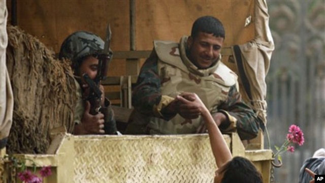 A demonstrator shakes hands with a soldier just outside Tahrir, or Liberation, Square in Cairo, Egypt, February 01, 2011