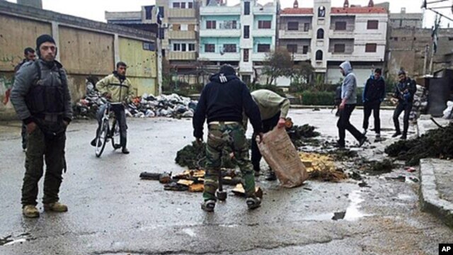 Syrian activists say two foreign journalists were killed Wednesday by government forces shelling the restive central city of Homs, Feb. 22, 2012.
