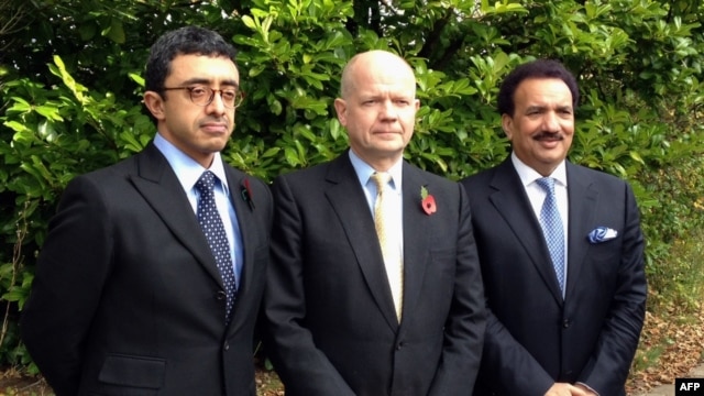 British Foreign Secretary William Hague (C), Emirati Foreign Minister Sheikh Abdullah bin Zayed al-Nahayan (L) and Pakistani Interior Minister Rehman Malik (R) posing for a picture during  their visit to the Queen Elizabeth Hospital,  where shot Pakistani schoolgirl Malala Yousafzai is receiving treatemnt, October 29, 2012. 