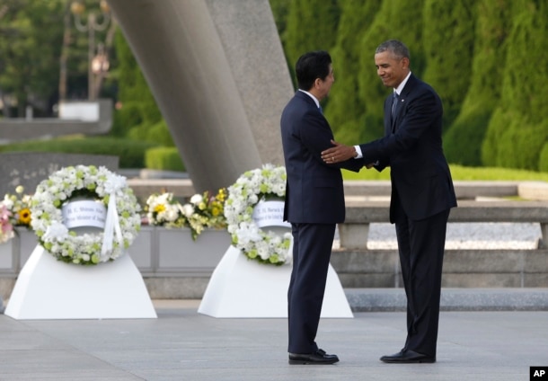 FILE - U.S. President Barack Obama, right, shakes hands with Japanese Prime Minister Shinzo Abe at Hiroshima Peace Memorial Park in Hiroshima, western Japan, May 27, 2016.