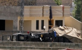 Vehicles are parked inside the compound of a house where it is believed bin Laden lived in Abbottabad, Pakistan.