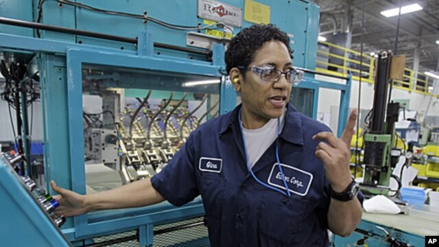 Gina Johnson performs leak tests on hydraulic fittings at the Eaton Corp. plant in Berea, Ohio, January 25, 2012.