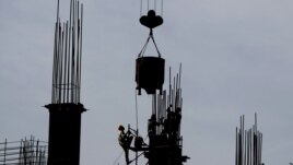Indian laborers work at a construction site in Mumbai, India, June 4, 2012