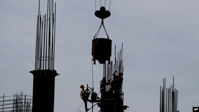 Indian laborers work at a construction site in Mumbai, India, June 4, 2012