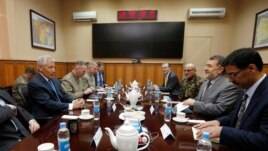 U.S. Secretary of Defense Chuck Hagel, left, meets with Afghanistan's Defense Minister Bismallah Khan Mohammadi, second right, at the ISAF (International Security Assistance Force) headquarters in Kabul, March 10, 2013.